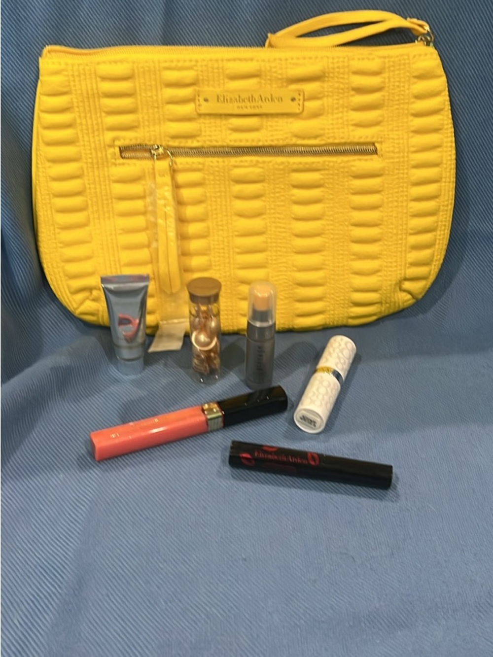 Elizabeth Arden Quilted Yellow Wristlet with Skin Care & Lip Products.